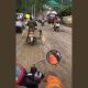 Seorang Pengendara Motor Melintasi Jalan Becek di Kawasan IKN